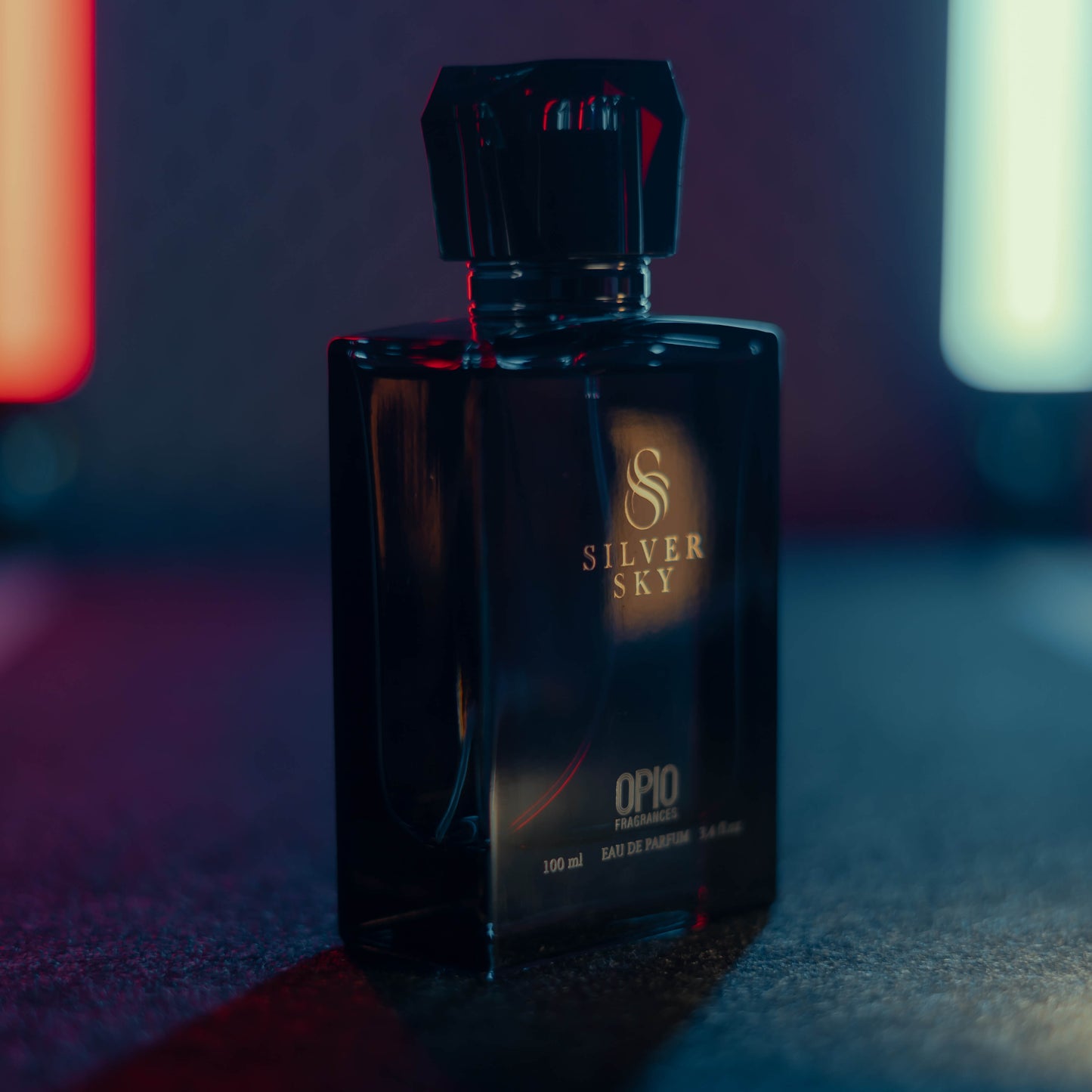A black perfume bottle with a clear liquid, branded Silver Sky by Opio.