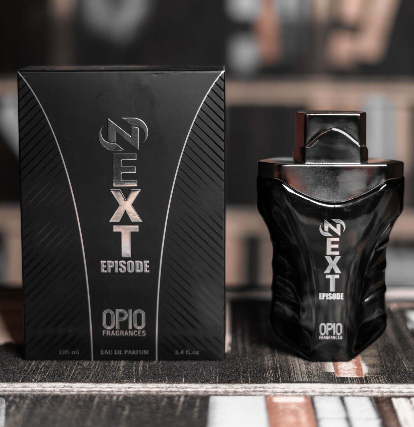 A bottle of 'NEXT EPISODE EDP' by OPIO, with a sleek black design and with box.