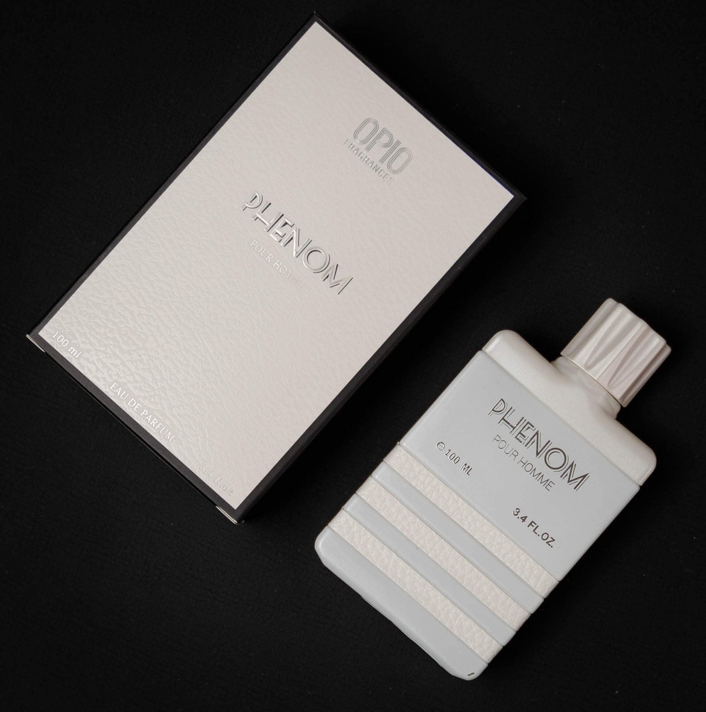 A bottle of Phenom EDP perfume with box for men, with a clear, elegant design, predominantly white.
