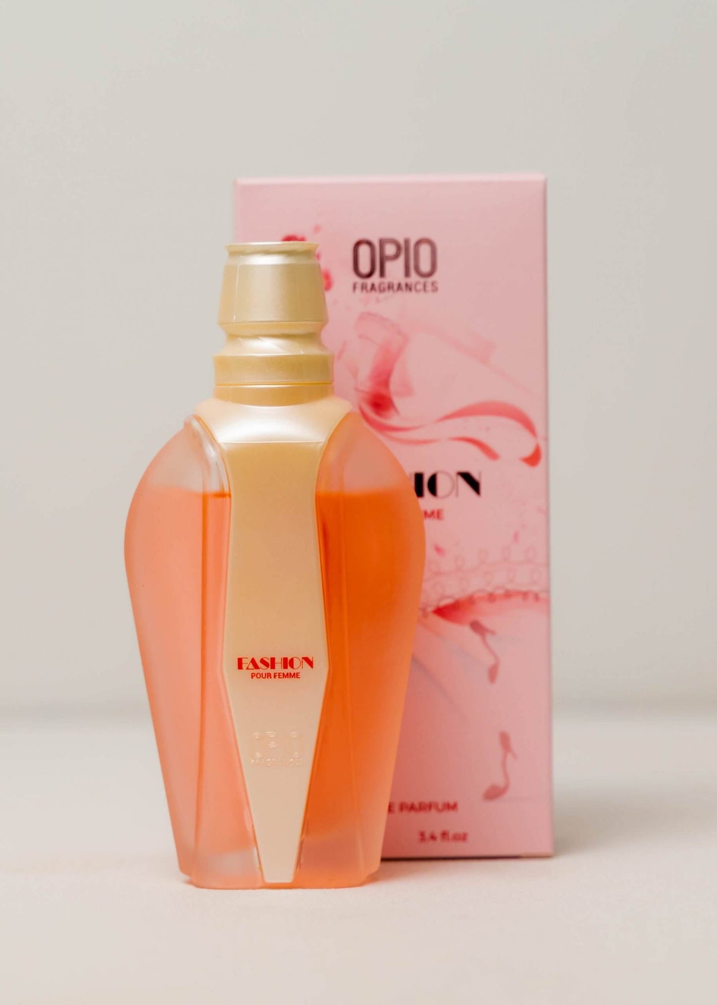 Peach-colored perfume bottle with a pearl strip in a light pink box decorated with musical notes.