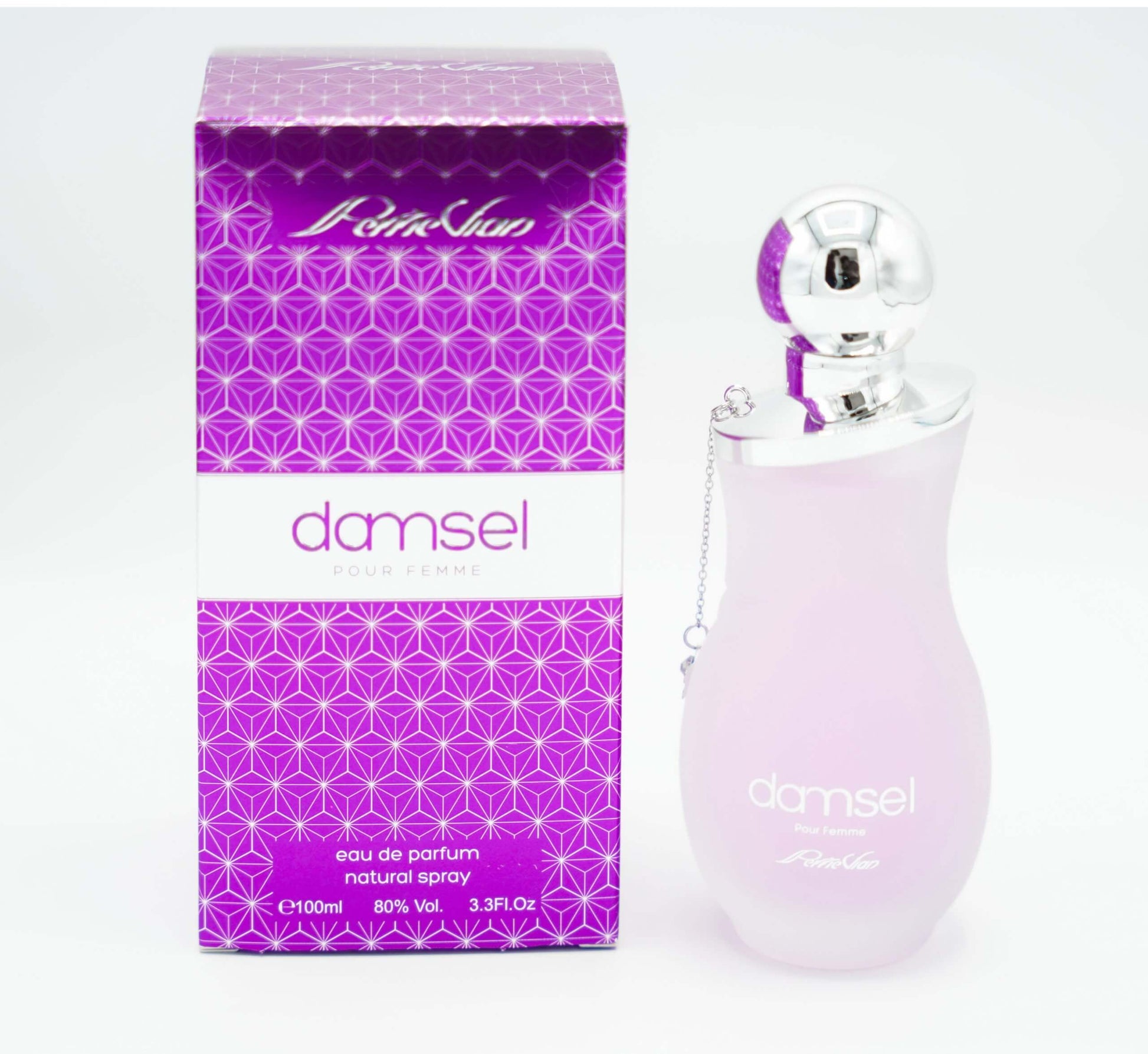 A pink bottle of DAMSEL EDP for women, with a silver cap, displayed on a white surface with purple flowers around it.