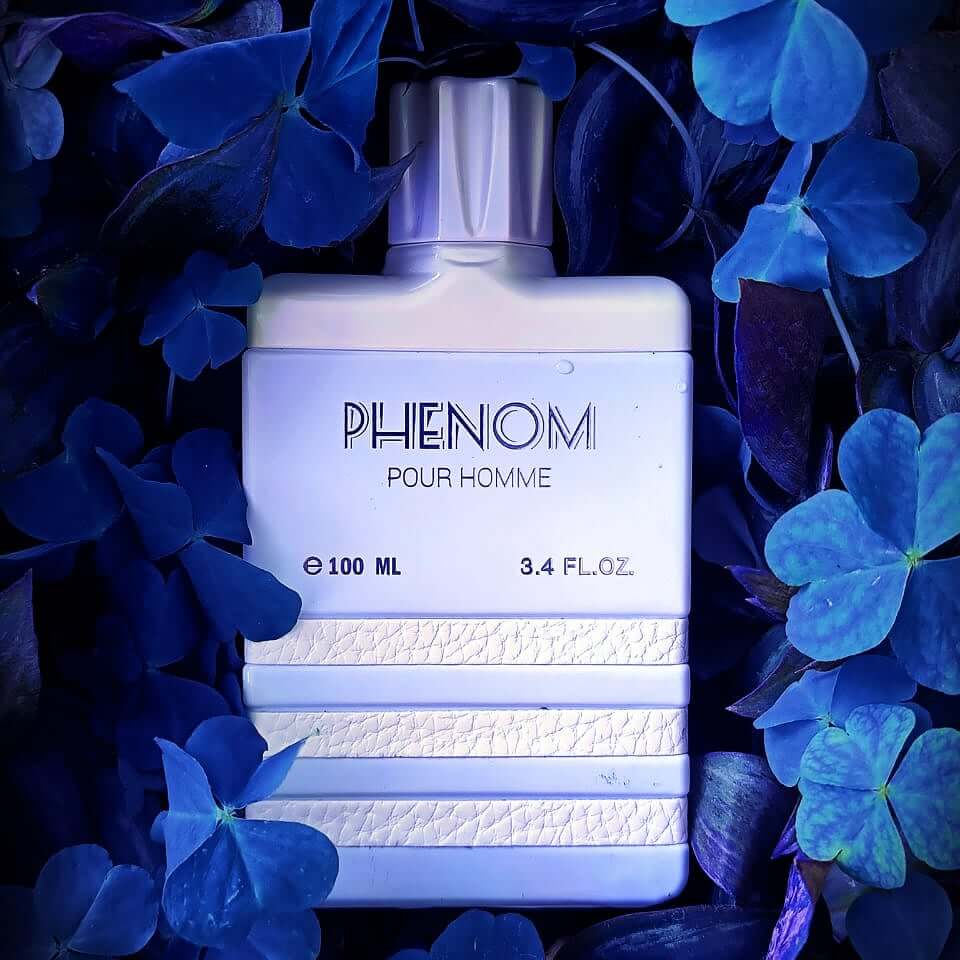 A bottle of Phenom EDP perfume for men, with a clear, elegant design, predominantly white.