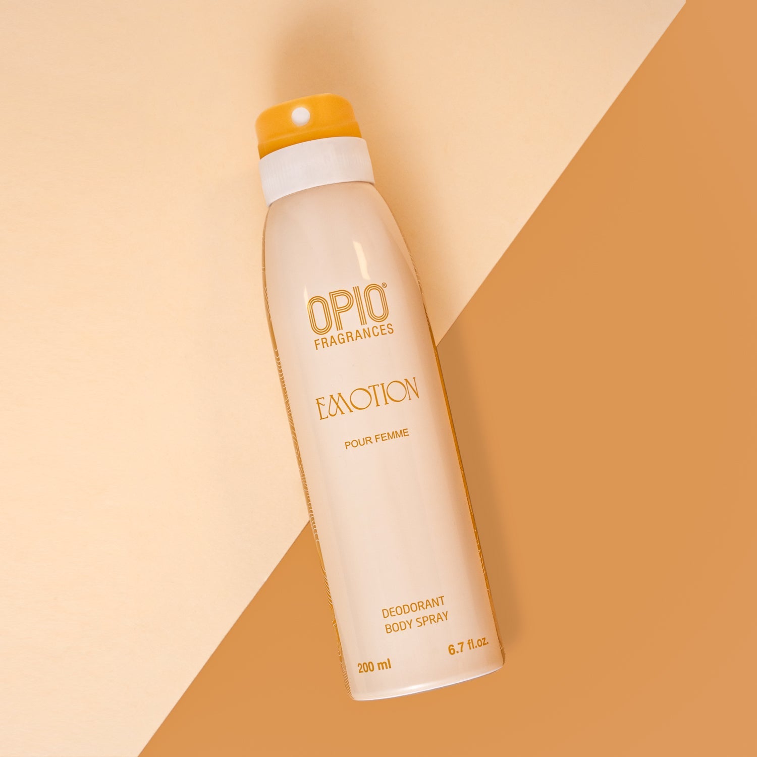 A spray bottle of EMOTION body spray for women by OPIO FRAGRANCES, with a beige and orange color scheme in the background.