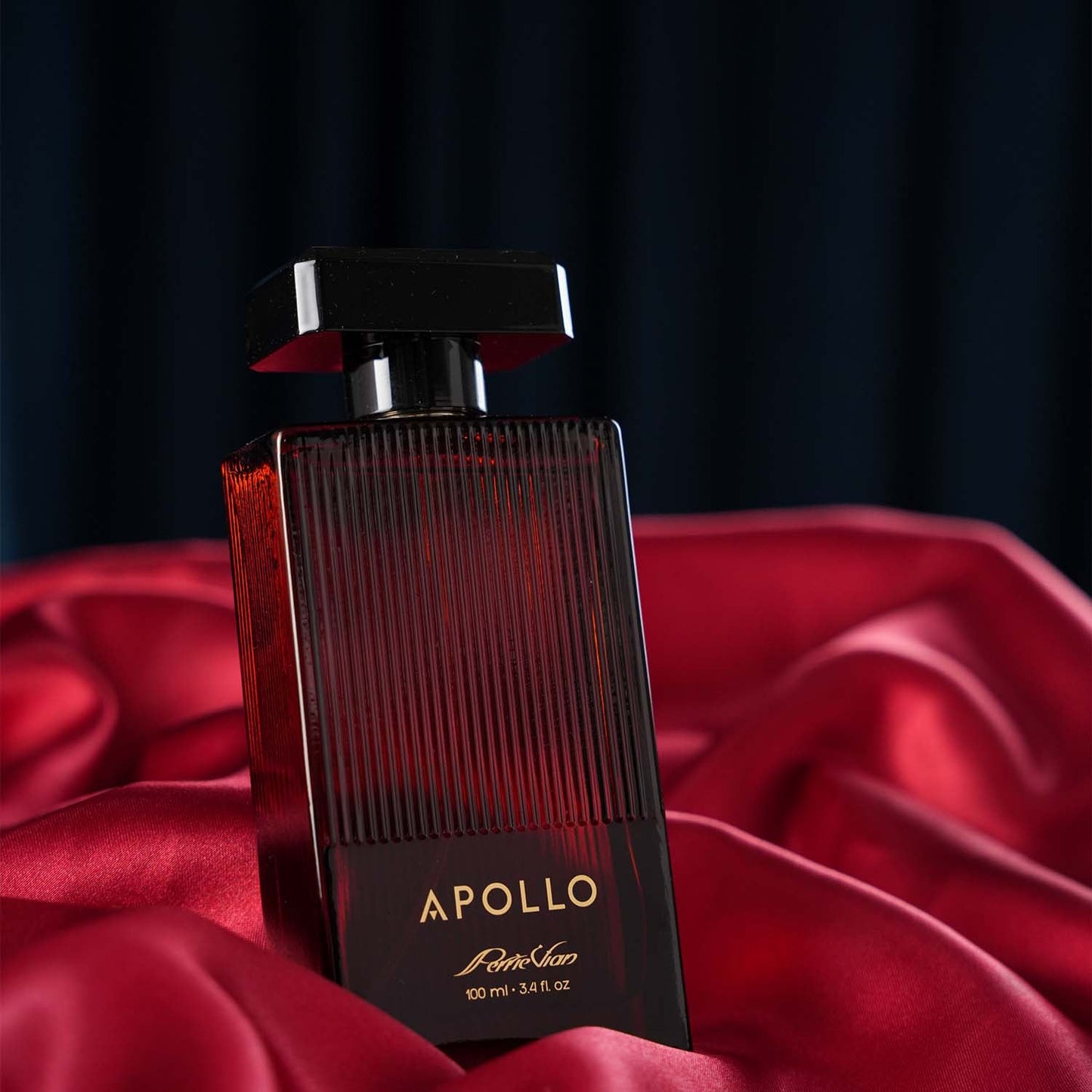 A bottle of APPOLO EDP for Men resting on a red fabric surface against a dark background, with a design featuring vertical lines and the brand name prominently displayed.