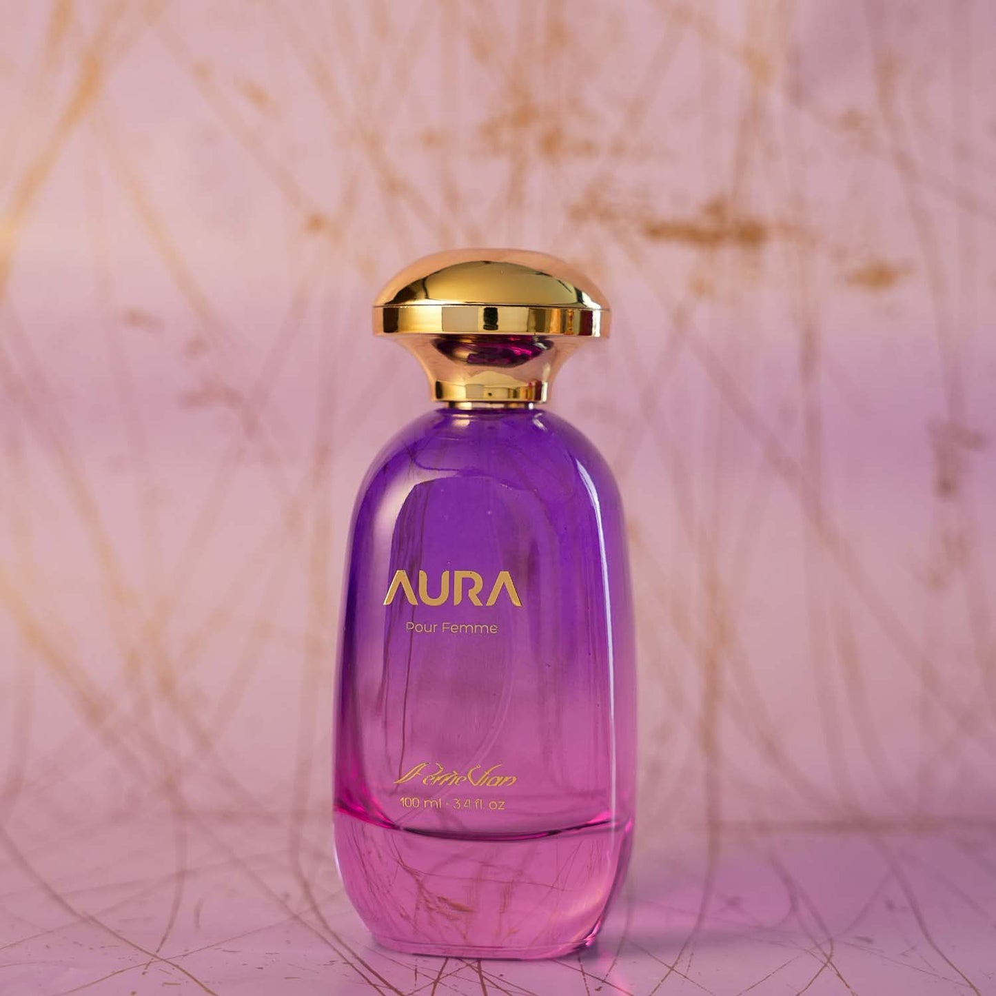 A purple colored perfume bottle with a gold cap. The label reads 'AURA' and 'EdP 100ml'.