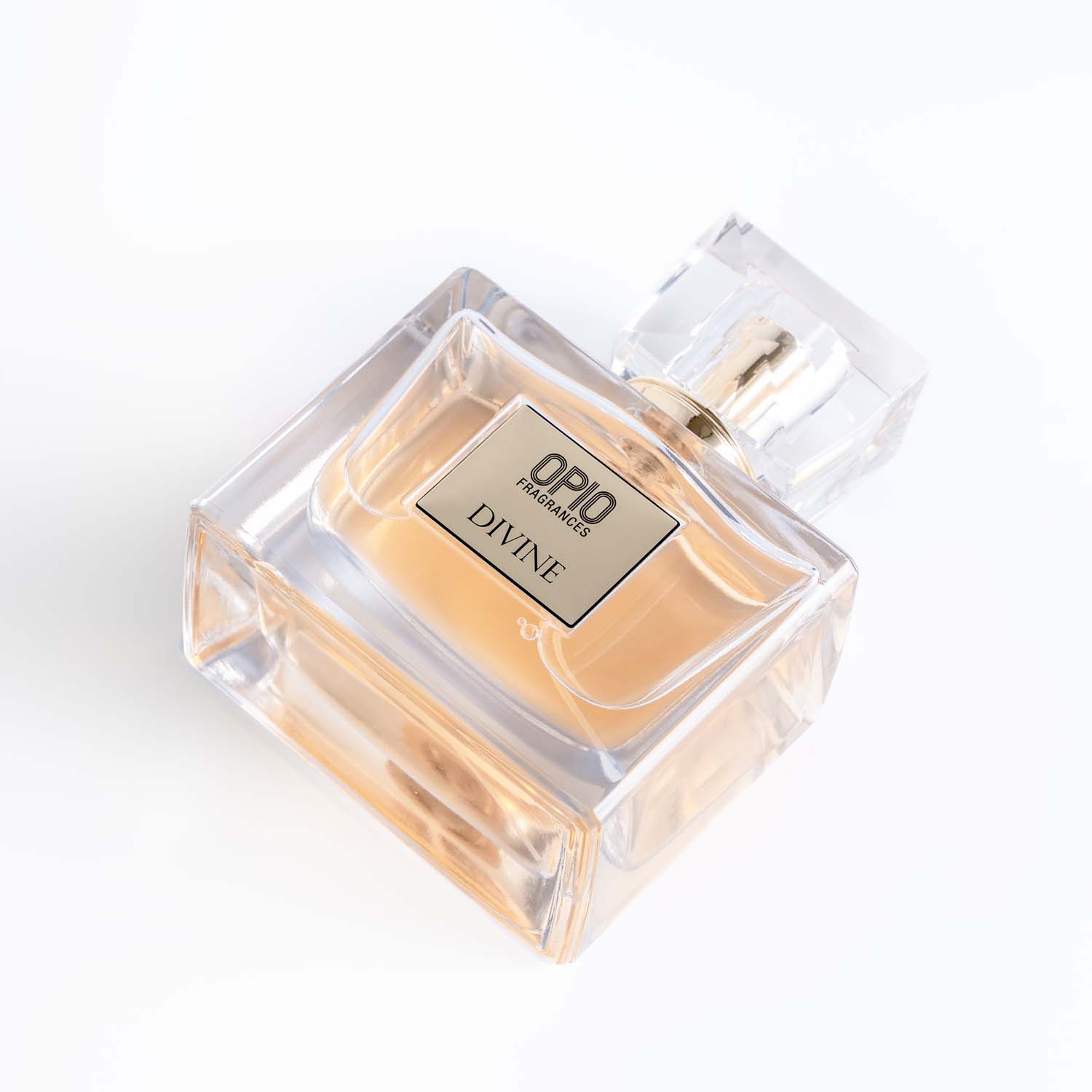 A clear bottle of perfume labeled 'DIVINE' with a transparent cap.