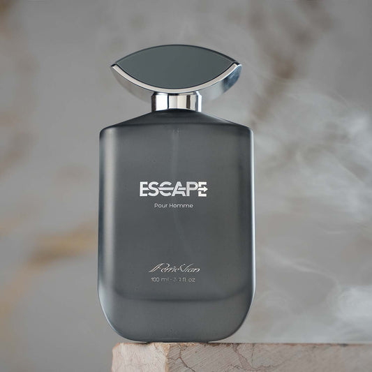 A bottle of ESCAPE EDP for men with a sleek design, featuring a dark hue and a silver cap, displayed against a blurred background with steam rising from the top of the bottle.