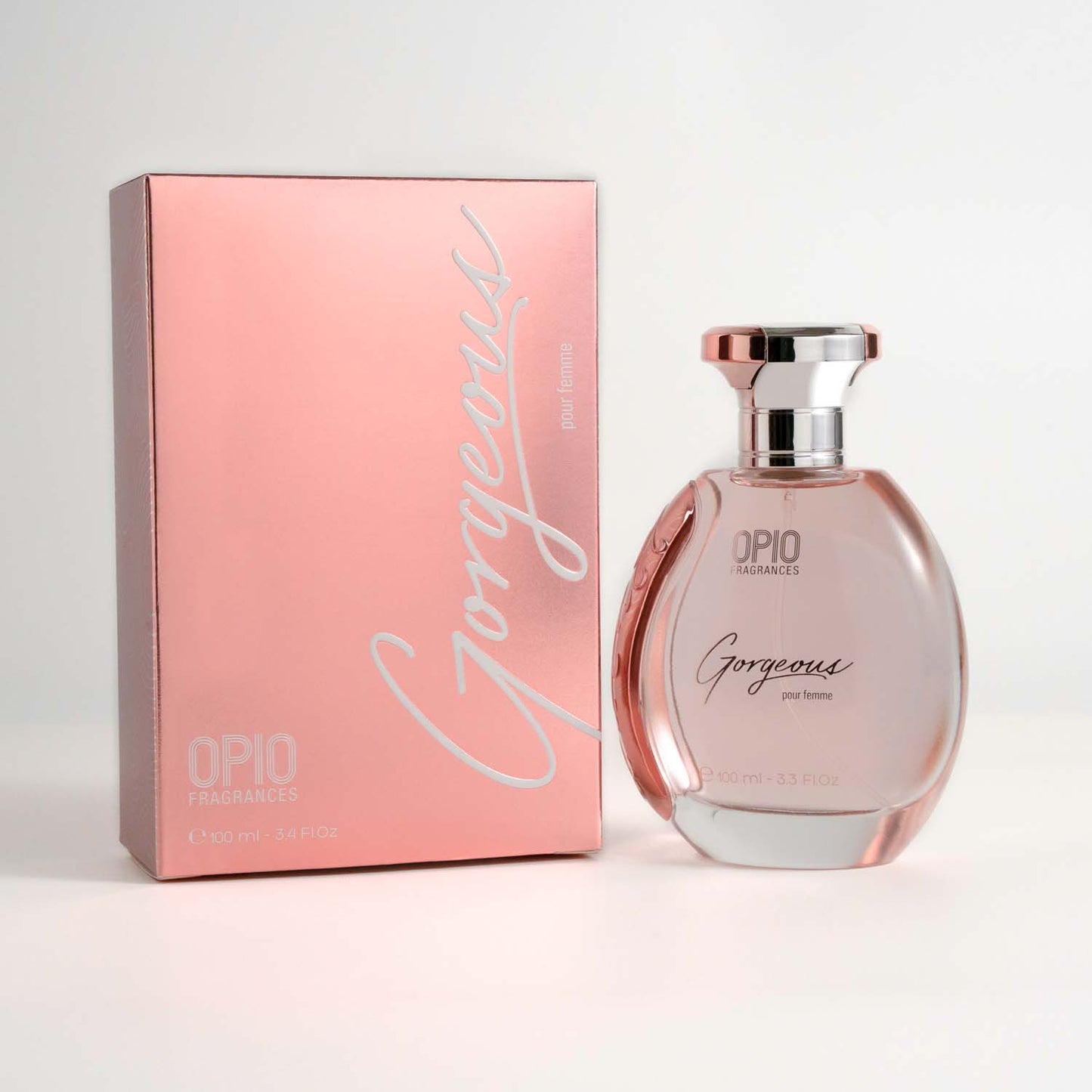 A bottle of OPIO Gorgeous women's fragrance, with a clear, pink-colored liquid visible inside and with box.