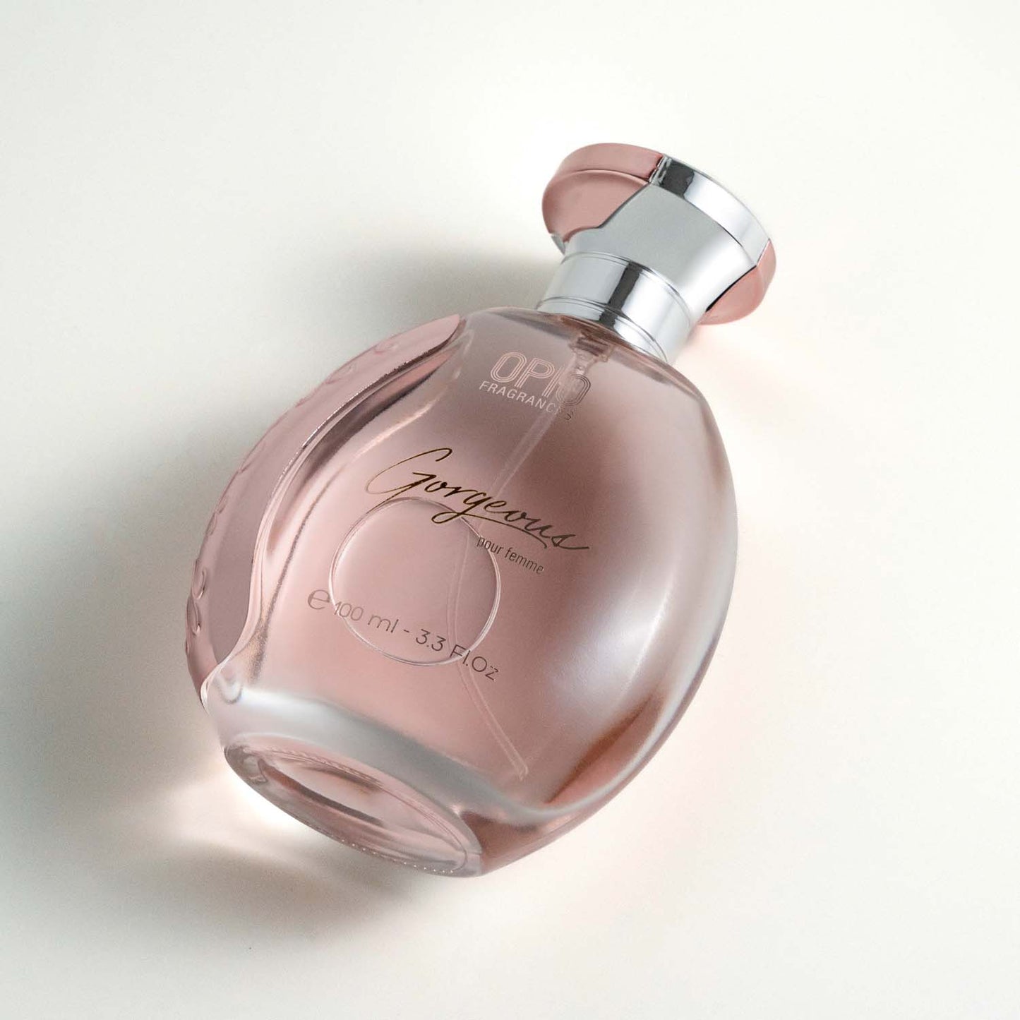 A bottle of OPIO Gorgeous women's fragrance, with a clear, pink-colored liquid visible inside.