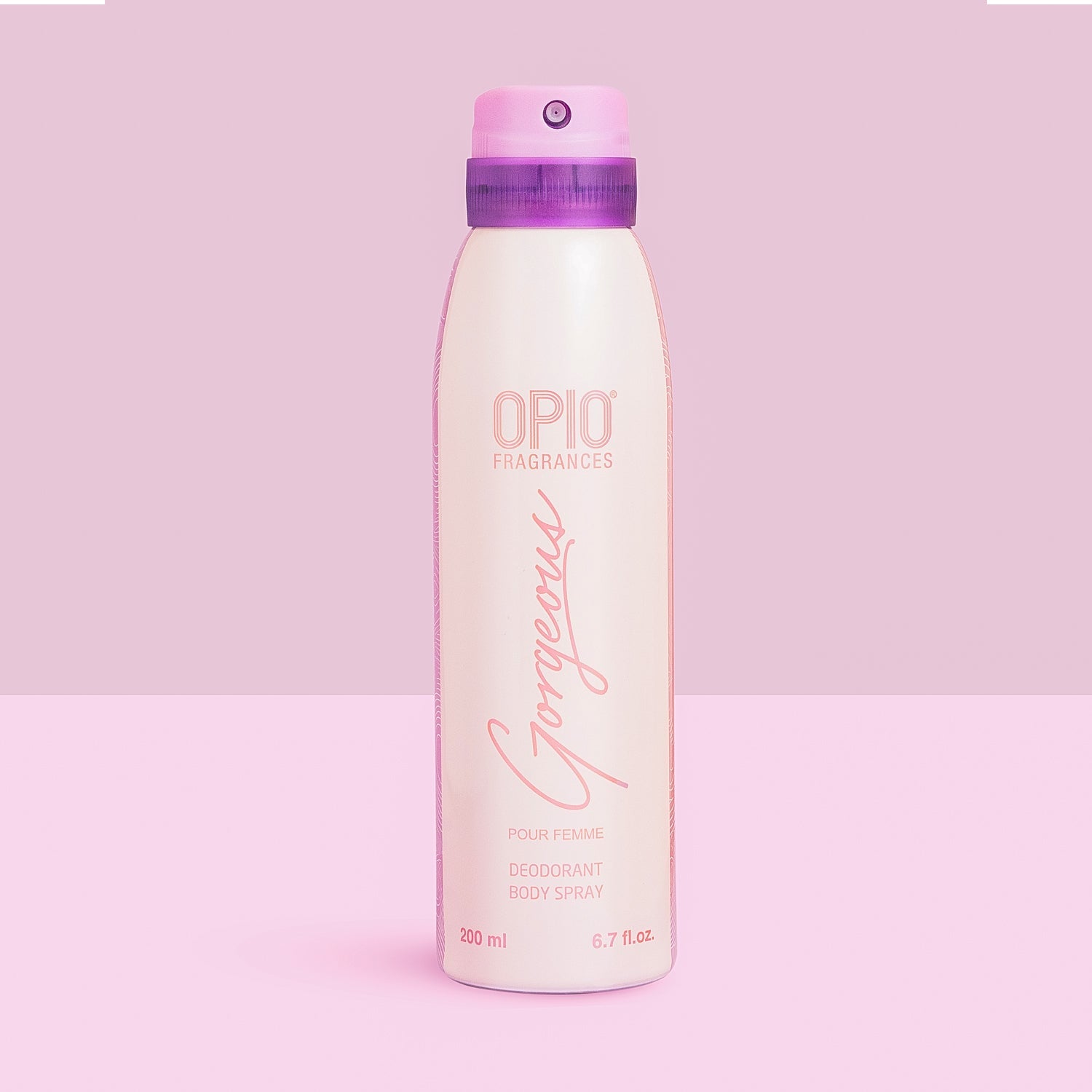 A bottle of OPIO Gorgeous body spray for women, with a pink cap and a label that includes the product name and the word 'Fragrances'.
