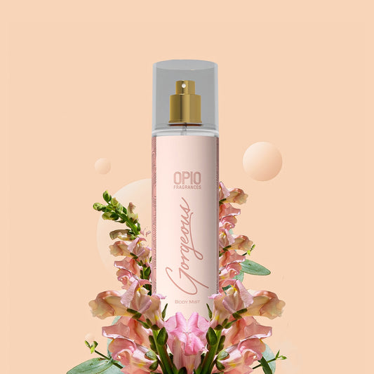 A bottle of body mist with a floral design, predominantly pink flowers, surrounding it.