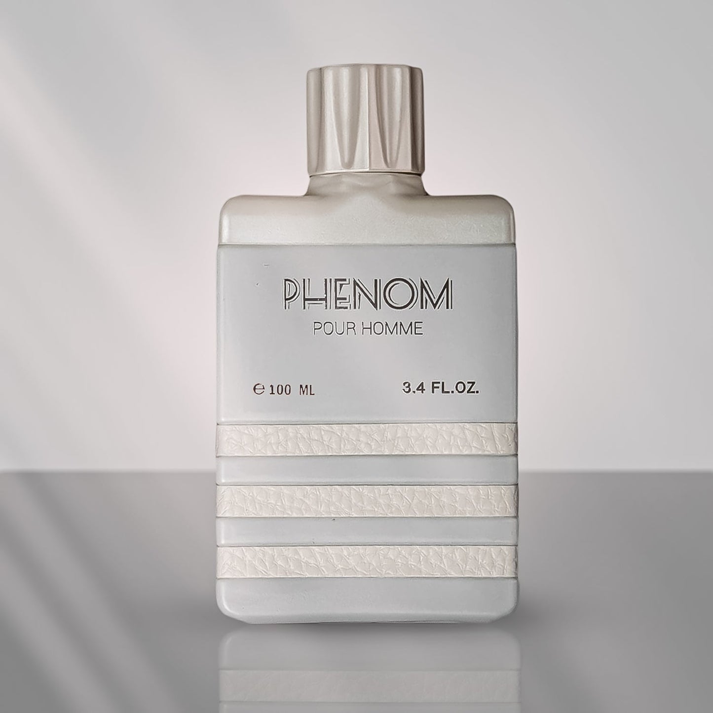 A bottle of Phenom EDP perfume for men, with a clear, elegant design, predominantly white with text and branding in a lighter shade.