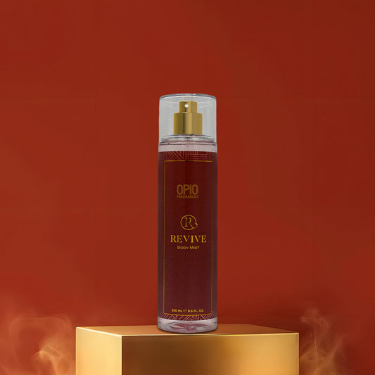 OPIO Revive body mist spray bottle on a gold platform with a red background