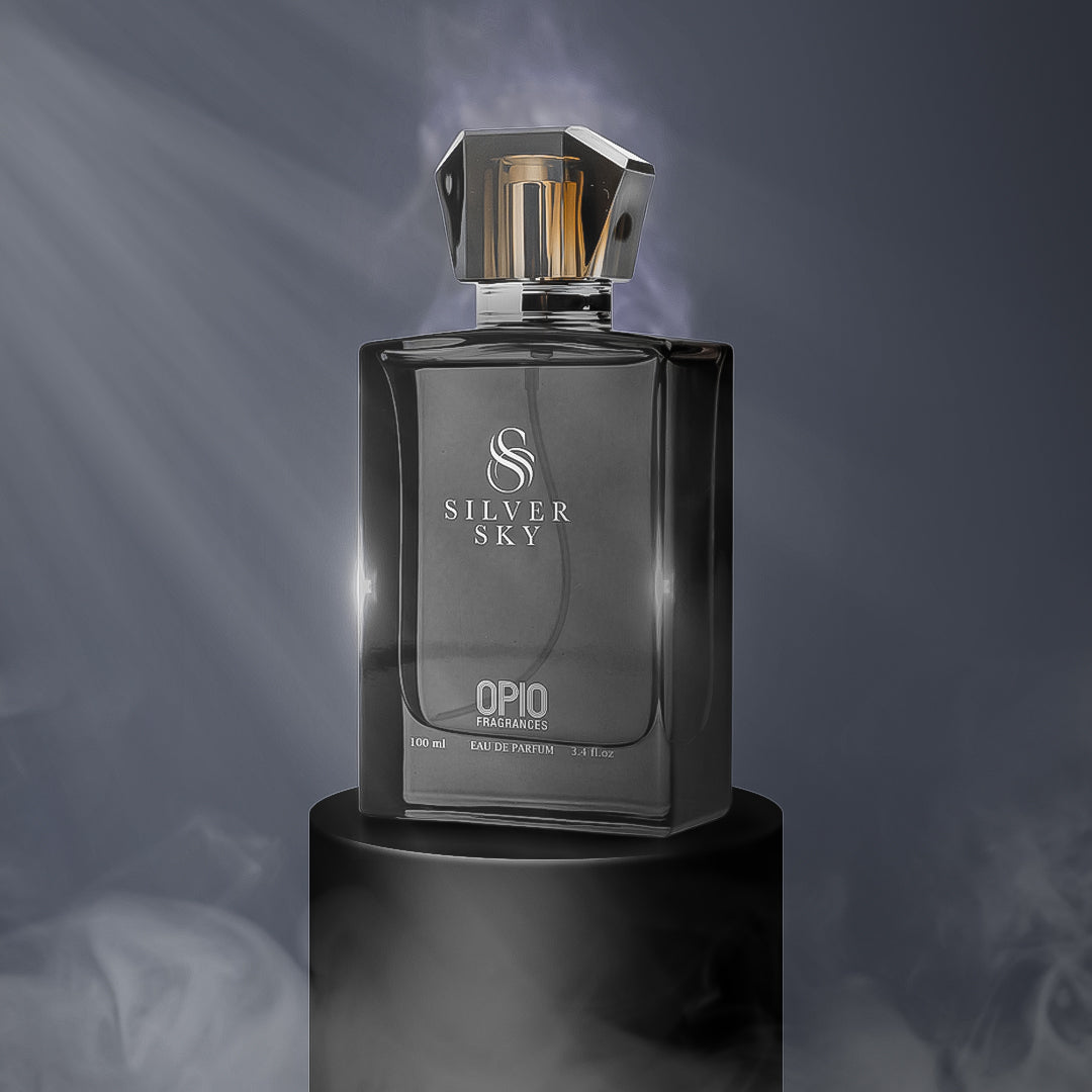 A black perfume bottle with a clear liquid, branded Silver Sky by Opio, presented on a dark background with smoke effect.