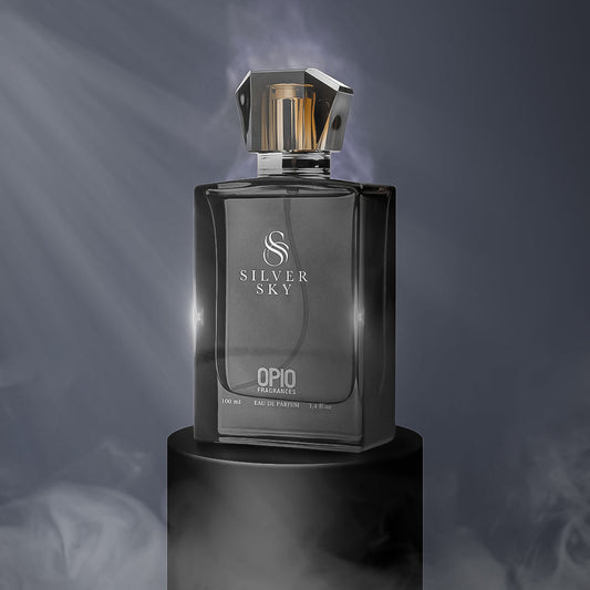 A black perfume bottle with a clear liquid, branded Silver Sky by Opio, presented on a dark background with smoke effect.