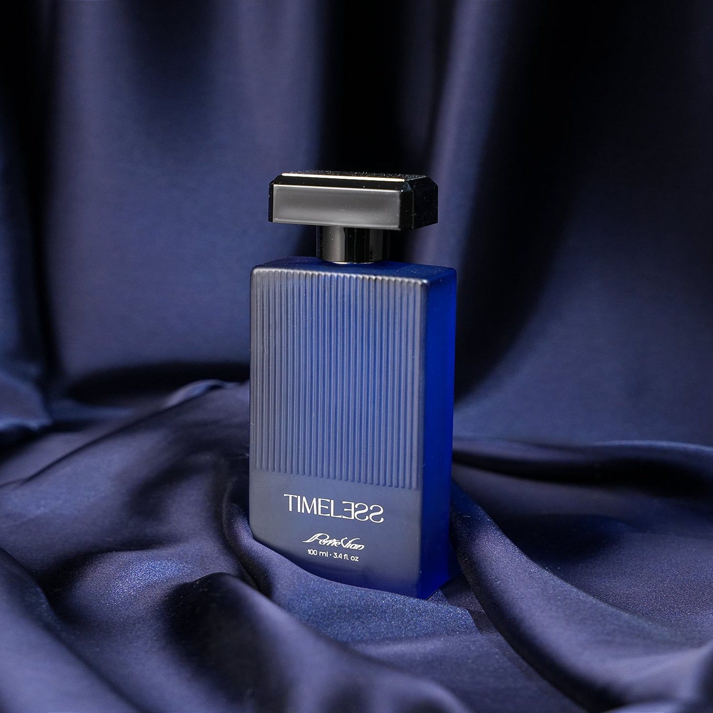 A bottle of TIMELESS EDP for men, with a blue and silver design, placed on a blue fabric surface.