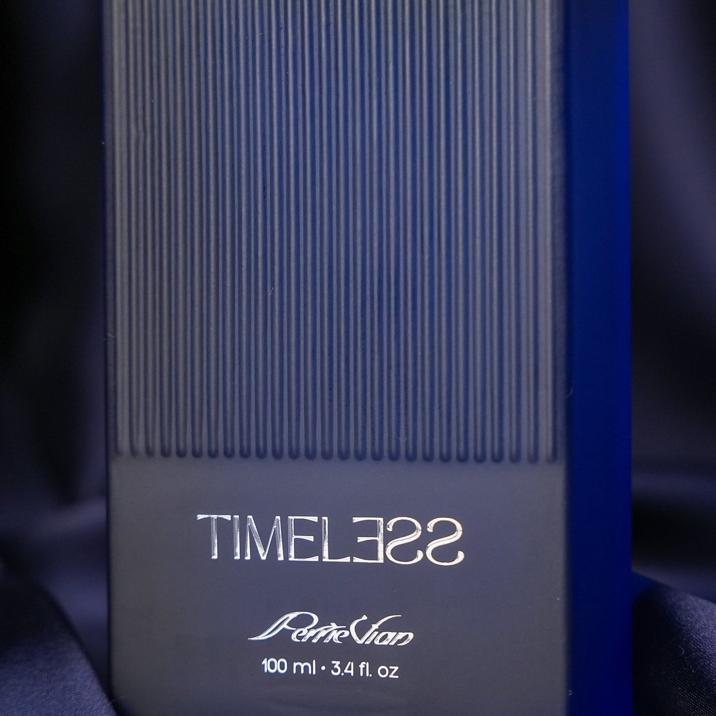 Close-up of a perfume bottle label with text and design details.