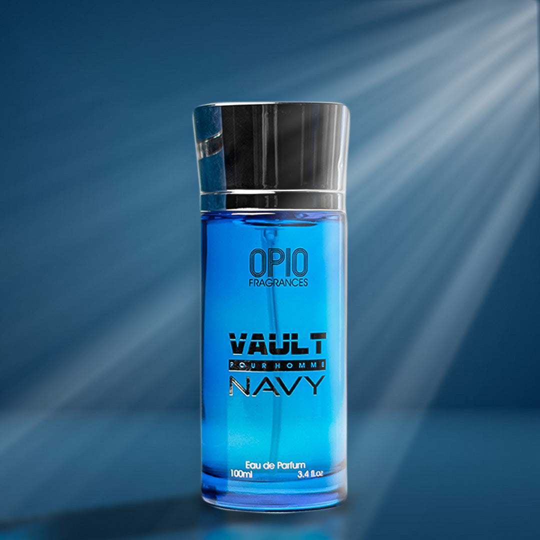 A bottle of 'VAULT NAVY EDP' by OPIO Fragrances, displayed in a blue-themed setting with a beam of light shining through the bottle.