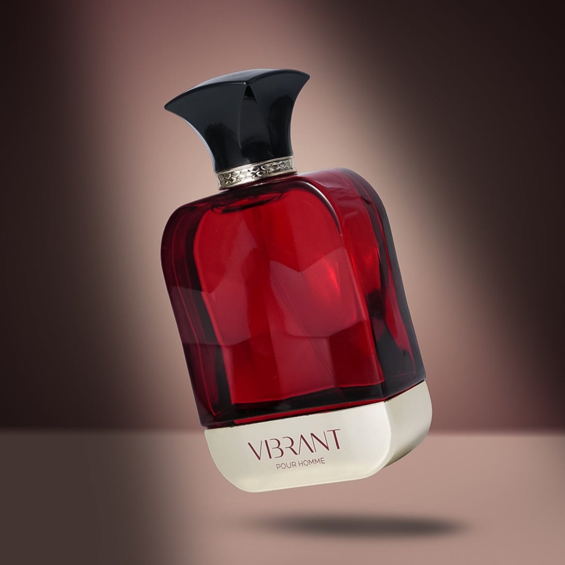 A stylish red and silver perfume bottle labeled 'VIBRANT POUR HOMME' with a black, sculpted cap, photographed against a soft, gradient brown background.